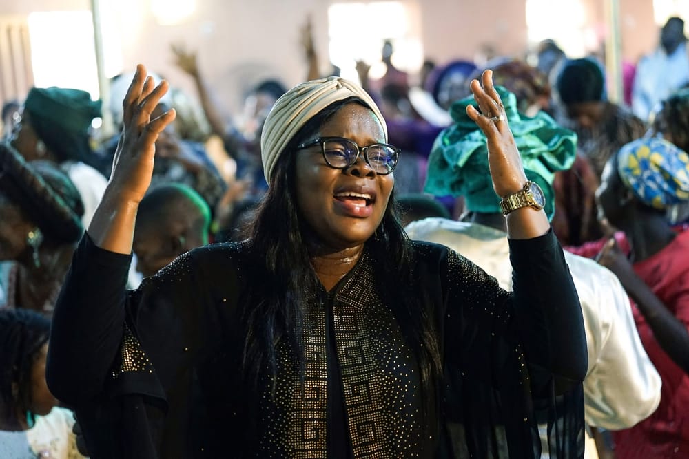 A member worshipping with hands raised